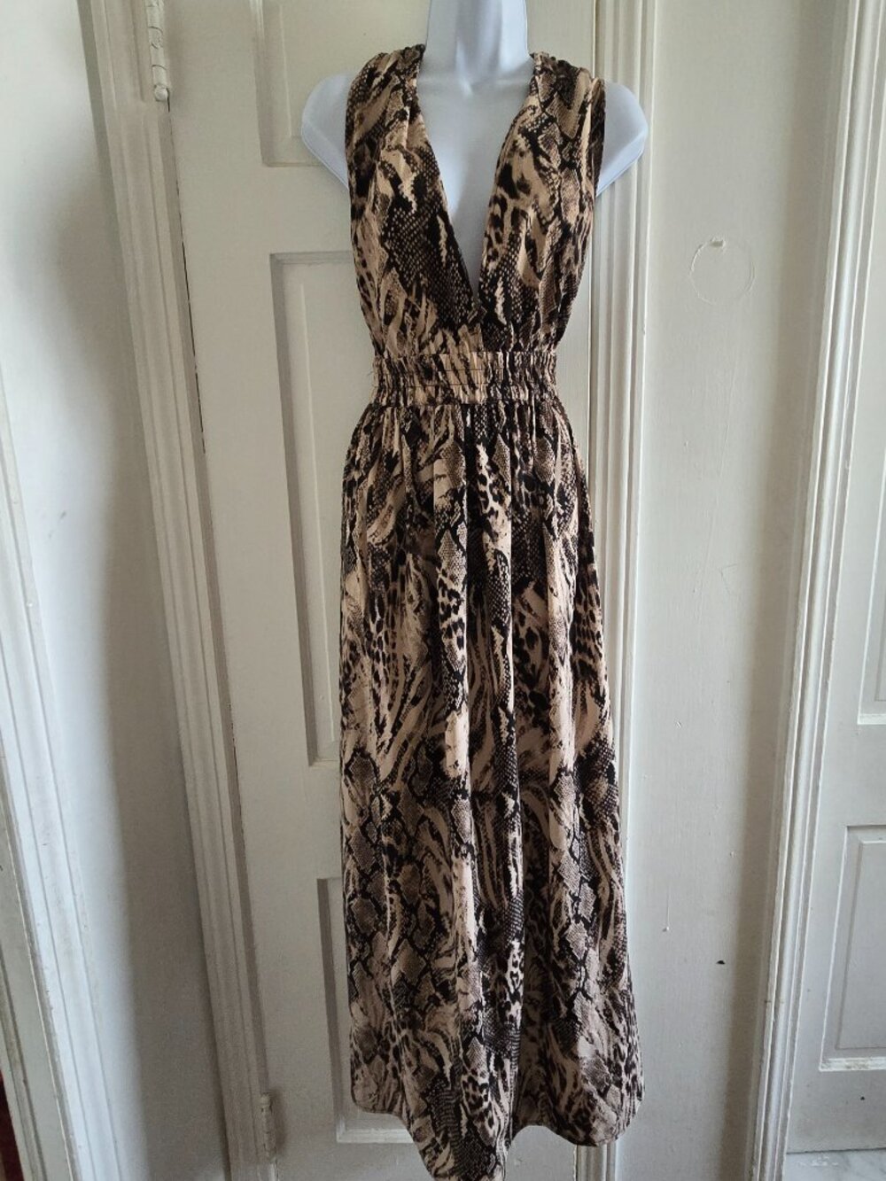 Sleeveless maxi dress featuring a beige and black animal snake print
